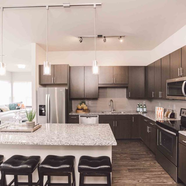Encore at Forest Park - Modern Kitchen with Granite Countertops and Bar Stools