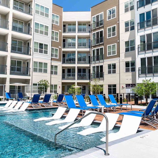 Encore at Forest Park - Outdoor Swimming Pool and Blue Lounge Chairs