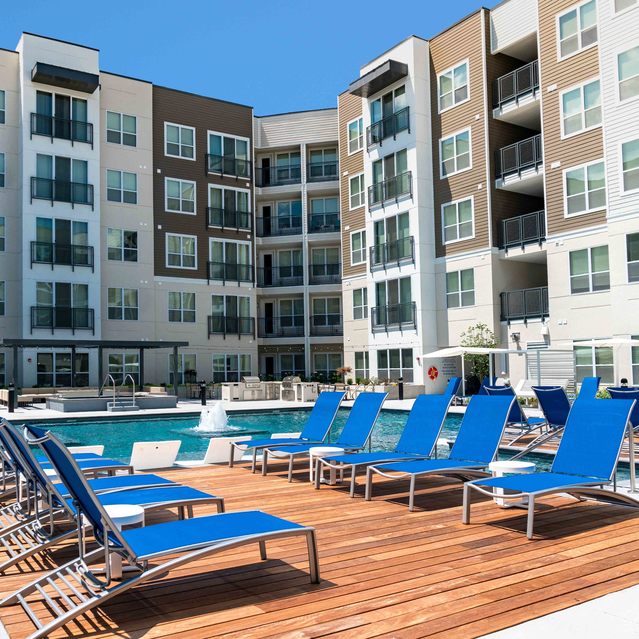 Encore at Forest Park - Blue Lounge Chairs on Wooden Deck and Swimming Pool