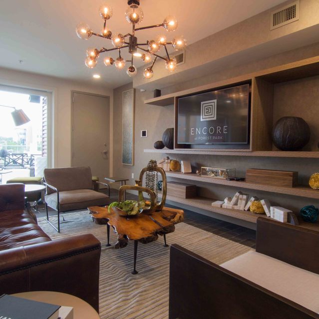 Encore at Forest Park - Modern Living Room Featuring Leather Sofa and Wooden Coffee Table