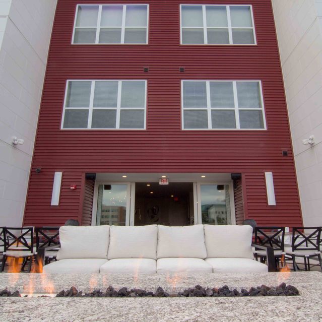 Encore at Forest Park - Exterior Apartment Building and Fire Pit With Flames
